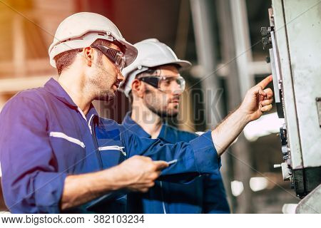 Industry Engineer Team Worker Teaching Help Friend Operate Control Heavy Machine In Factory