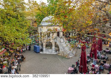 Bursa, Turkey - October 13, 2019: Tea gardens and silk shops in Koza Han Silk Bazaar. Koza Han is historical place from Ottoman times in Bursa, Turkey