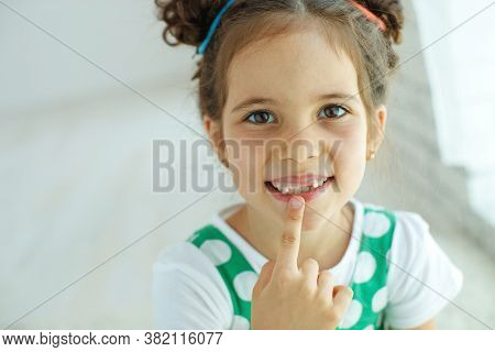 Little Girl With No Tooth. The Child Lost A Tooth. High Quality Photo.