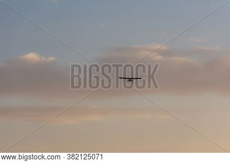 The Cornhusker Plane Is High In The Sky. Fly-around On A Small Plane. Sunset Sky With Clouds And A P