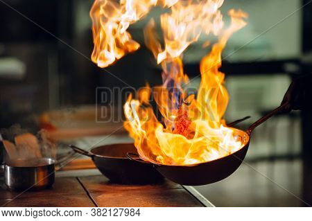 Modern Kitchen. Cooks Prepare Meals On The Stove In The Kitchen Of The Restaurant Or Hotel. The Fire