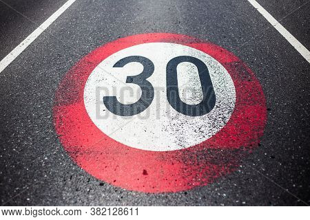 30km/h Speed Limit Sign Painted On Asphalting Road.