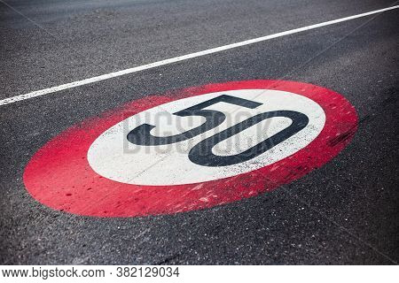 50km/h Speed Limit Sign Painted On Asphalting Road.