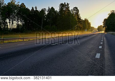 Early Sunrise Over Straight Road With Deminishing Perspctive