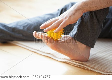 man doing flatfoot correction self massage at home