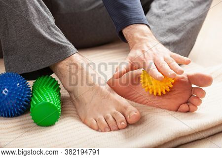 man doing flatfoot correction self massage at home