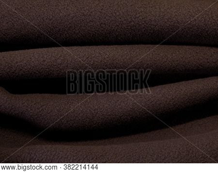 Blanket made of fluffy fleece fabric. The background is made of soft plush fleece material with a lo