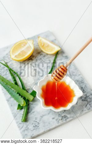 Natural Ingredients For Homemade Body Salt Scrub. Honey, Sea Salt And Lemon. Skincare Organic, Self-
