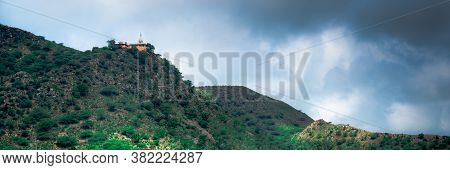 Hindu Temple On A Hill Covered In Vegetation With The Tower And Spire Clearly Visible In The Distanc