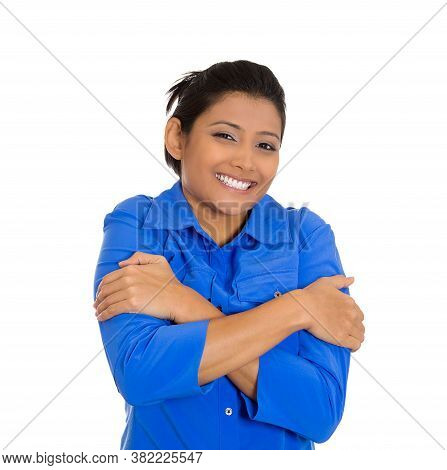 Portrait Of A Pretty Young Woman Holding Hugging Herself, Isolated On White