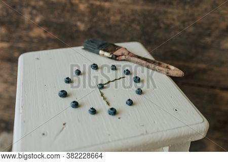 Berries Folded In A Circle In The Shape Of A Clock. Blue Paint Brush