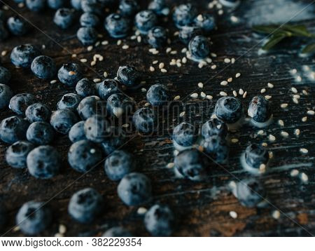 Blueberries Are Scattered On An Old Brown Wooden Cracked Table