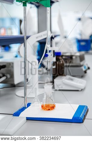 Flasks With Brown Liquid, Science And Medical Research And Development Concept. Vaccine Manufacturin