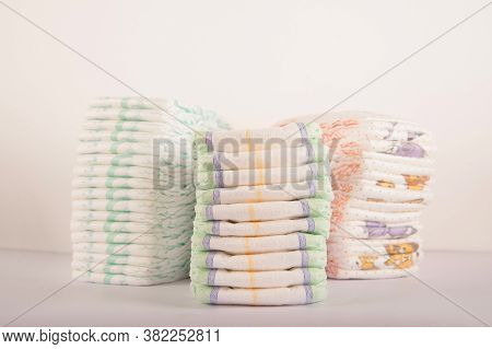 Baby Diapers On A White Background Close-up And Copy Space. Accessories For A Newborn Diapers, Pacif