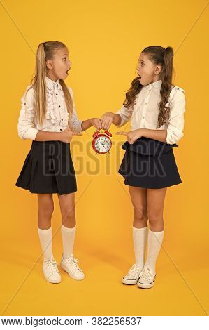 Schoolgirls And Alarm Clock. Children School Pupils. Knowledge Day. School Time. Surprised Shocked K