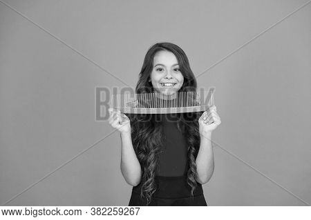 Say Goodbye To Knots And Tangles. Happy Child Hold Comb Brown Background. Hair Combing. Combing Befo