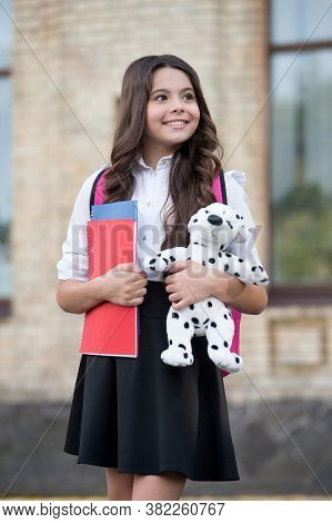 We Teach You Learn. Happy Child Hold Toy And Books Outdoors. Back To School Essentials. Primary Educ