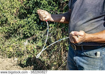 Man With His Divining Rod In Hands Searching For Water