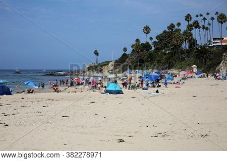 Laguna Beach, California / USA - August 23, 2020: People enjoy the beach in Laguna Beach California during the Coronavirus Pandemic. Editorial Use Only