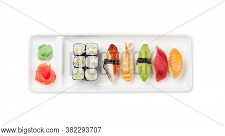 Japanese sushi set. Sashimi, maki rolls on plate. Top view flat lay isolated on white background