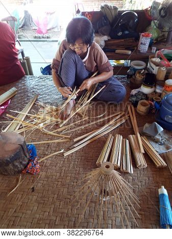 Bor Sang, Chiang Mai, Thailand, December 22, 2018: Craftswoman Cutting Bamboo To Make Umbrellas At B