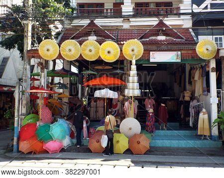 Bor Sang, Chiang Mai, Thailand, December 22, 2018: Two People Look At The Umbrellas Displayed For Sa