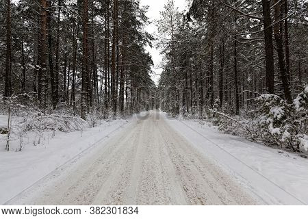 Tracks From The Tread Of A Car Tire In The Snow In The Winter Season, Tracks On The Site Of The Road