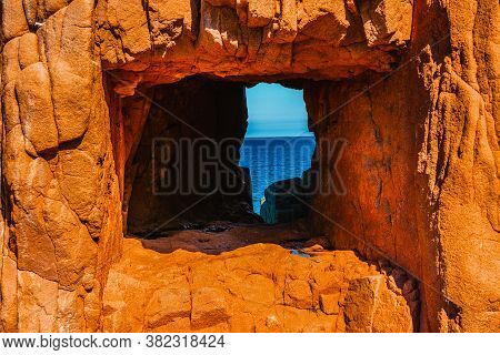 Hole In The Rocks In Rocce Rosse Beach In Sardinia, Italy