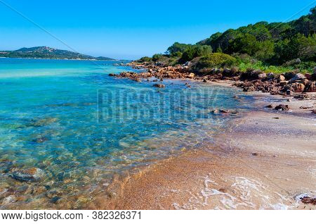 Rocks And Clear Water In Lu Impostu Beach In Costa Smeralda. Sardinia, Italy
