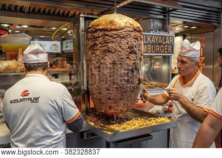 Istanbul, Turkey - October 11, 2019: Chef cutting traditional Turkish food Doner Kebab in the restaurant in Istanbul, Turkey.