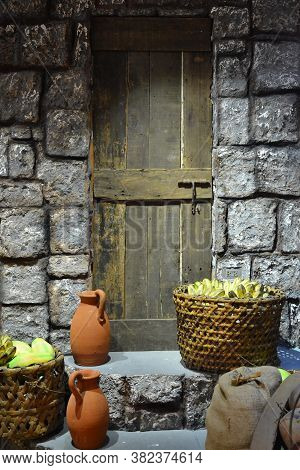 Claypot Water Jar And Basket Of Fruits Outside The Doorstep In Chinatown, Philippines.