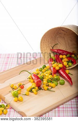 Colored Peppers Fallen From A Basket On A Table, Selective Focus.