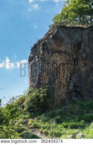 A Rock Wall Of The Stenzelberg Against The Blue Sky.