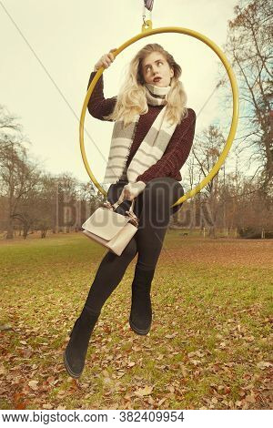 Nice Lady Posing In Autumn Park And Exercising With Steel Hoop