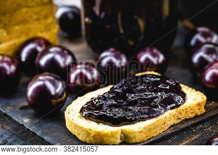 Toast With Grape Jam, On Rustic Wooden Table. Jabuticaba, Exotic Brazilian Fruit, Used In Cooking, A