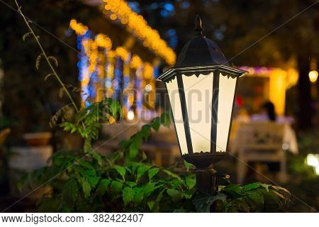 Iron Retro Lantern Of Street Lighting Glowe With Warm Light In The Night Garden Of The Backyard Clos