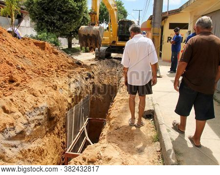 Eunapolis, Bahia / Brazil - November 17, 2010: Backhoe Machine Works On The Implementation Of A Sewa