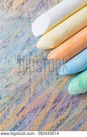 Crayons with colorful painted background. Back to school and art concept with copy space.