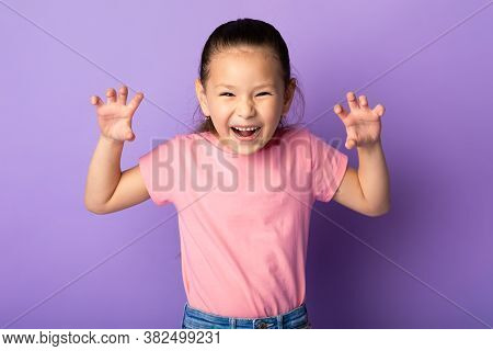 Funny Tiger. Portrait Of Cute Playful Little Asian Kid Showing Claws, Purple Studio Background