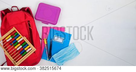 Backpack, Food Box, Notebooks, Pens, Abacus And Sanitary Mask On A White Background