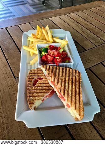 Turkish Fast Food Menu Toast With Salad And Potatoes / Club Sandwich Tost On Wooden Table.