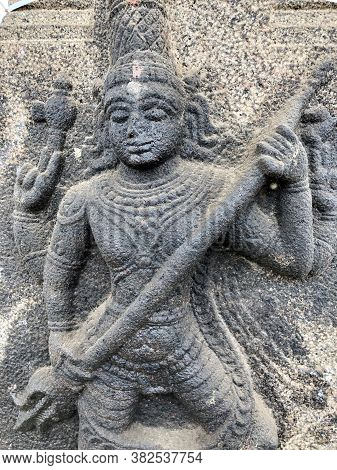 Sculpture Of Shiva Holding A Trishula. Bas Relief Sculpture Carved In The Stone Wall Of Shiva Temple