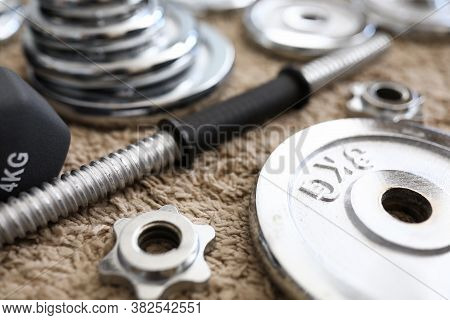 Carpet Apartment Are Disassembled Metal Dumbbells. An Effective Home-based Strength Training Program