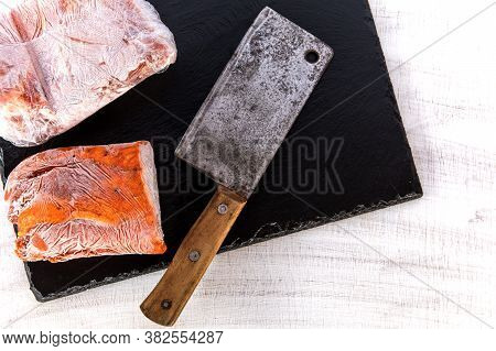 Frozen Raw Pork Neck Chops Meat Steak Isolated On Slate. Frozen Uncooked Slices Of Beef Steaks, Tend