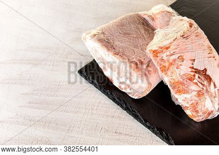 Frozen Raw Pork Neck Chops Meat Steak Isolated On Slate. Frozen Uncooked Slices Of Beef Steaks, Tend
