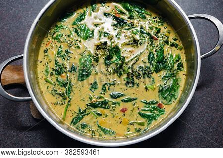 Plant-based Food,  Vegan Green Curry With Spinach Broccolini Kale And Stir Fry Vegetables In The Pan