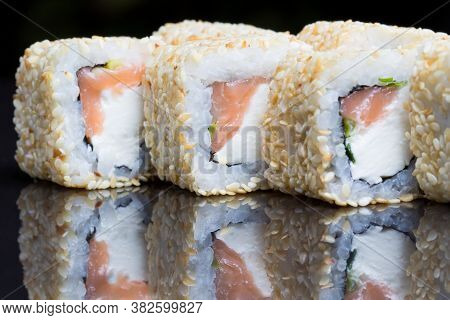 Sushi Rolls Shake Chizu With Sesame On A Black Background.