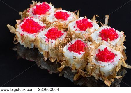 Sushi Rolls With Tuna Or Salmon Shavings On A Black Background.