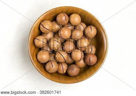 Natural Organic Macadamia Nuts In Wooden Bowl On Gray Concrete Background Flat Lay Top View Healthy 
