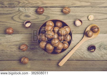 Natural Organic Macadamia Nuts In Bowl On Wooden Table Flat Lay Top View Healthy Snack Nuts Contain 